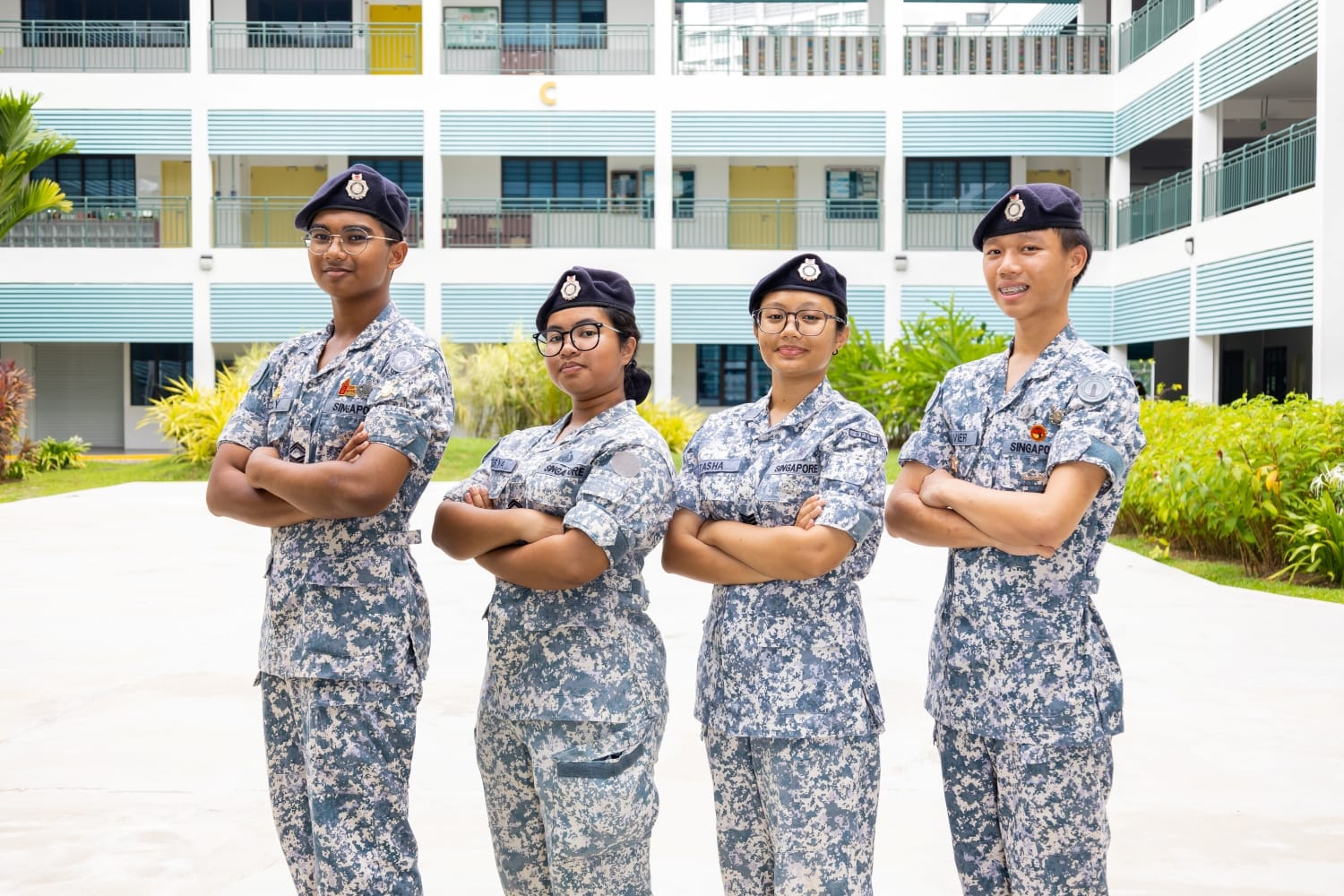 4 students in NCC (Sea) uniform posing with arms crossed